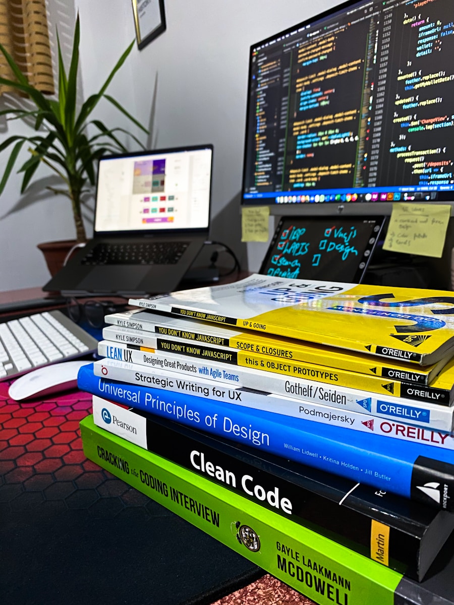 Photo by Nangialai Stoman a stack of books sitting in front of a computer