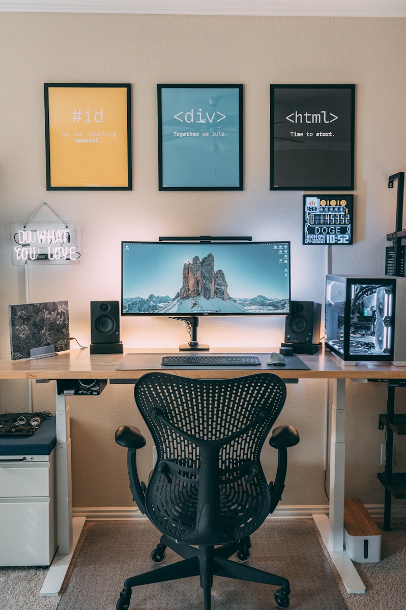 Photo by Chen a desk with a computer and speakers on it